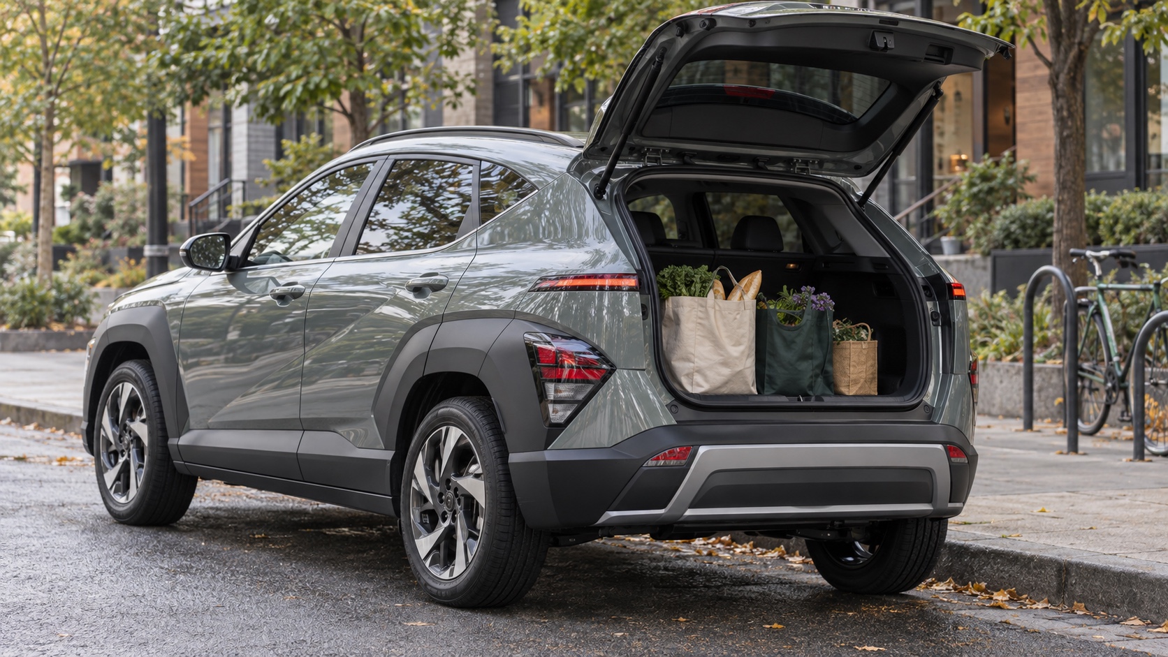 A compact gray crossover with its hatch open and grocery bags arranged in the cargo area.