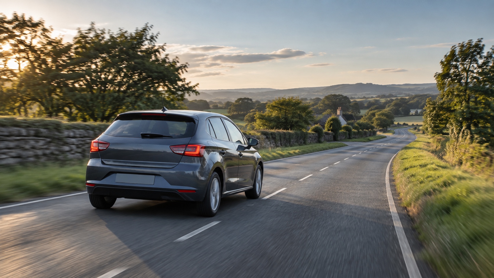 Unbranded compact car taking a calm late-afternoon drive on a dry country road after a period of limited use.