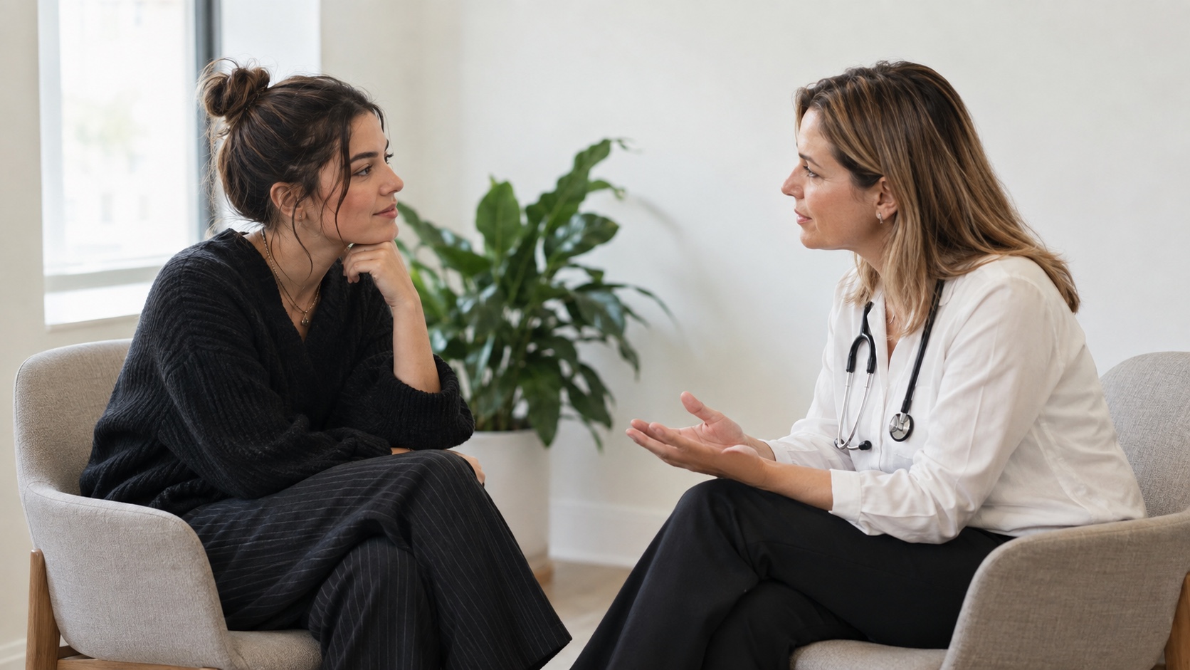 Adult fashion worker having a private, supportive conversation with a healthcare professional.